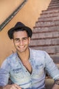 Handsome man sitting on stairs smiling Royalty Free Stock Photo