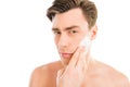 Handsome man smearing foam for shave on his face Royalty Free Stock Photo