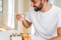 Handsome man smiling happy enjoying eating fresh colorful asian sushi using chopsticks Royalty Free Stock Photo