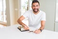 Handsome man smiling happy enjoying eating fresh colorful asian sushi using chopsticks Royalty Free Stock Photo