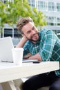 Handsome man smiling outside with laptop Royalty Free Stock Photo