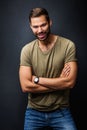 Handsome man smiling, standing confident with crossed arms