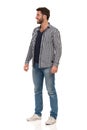 Handsome Man In Sneakers, Jeans, Lumberjack Shirt And Glasses Is Standing, Looking Away And Smiling Royalty Free Stock Photo