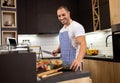 Handsome man in some home cooking action enjoying himself in the kitchen Royalty Free Stock Photo