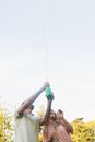 Handsome man spraying bottle of champagne with blonde partner