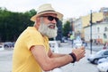 Handsome man standing with plastic bottle of water Royalty Free Stock Photo