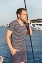 Handsome man standing on a sailing boat - sailing trip. Royalty Free Stock Photo