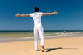 Handsome man standing in the sun on beach