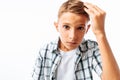 Handsome man straightens his hair, teen boy changes hairstyle, in Studio on white background