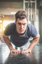 Handsome man and strong guy doing push ups exercise in fitness gym Royalty Free Stock Photo