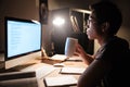 Handsome man studying with computer and drinking tea Royalty Free Stock Photo