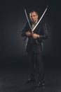 handsome man in suit with dual katana swords Royalty Free Stock Photo