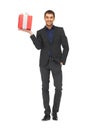 Handsome man in suit with a gift box Royalty Free Stock Photo