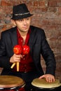 Handsome man in suit and hat poses with maracas Royalty Free Stock Photo
