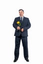 A handsome man in a suit with a large yellow flower Royalty Free Stock Photo