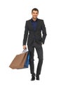 Handsome man in suit with shopping bags