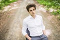 Handsome man in suit sitting on office chair on road in green forest. Business concept Royalty Free Stock Photo