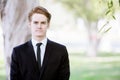 Handsome man in a suit standing in park Royalty Free Stock Photo