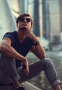 Handsome man in sunglasses sitting and thinking about life on ci Royalty Free Stock Photo