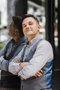 Handsome man in sunlight. Man on cityscape and buildings with reflections of city. Businessman in vest.