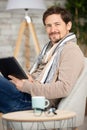 handsome man surfing on tablet on couch Royalty Free Stock Photo