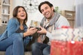 handsome man surprising girl with christmas gift