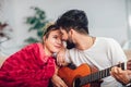 Young man taking care of his sick girlfriend lying on the sofa