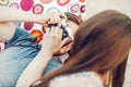 Handsome man taking picture of a beautiful brunette girl, hipster couple with old film camera making photographs on a hammock near Royalty Free Stock Photo