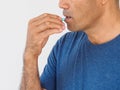 Handsome man taking pill on white background. Healthcare and med Royalty Free Stock Photo