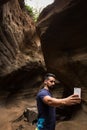 Handsome man taking selfie in canyon in Gran Canaria