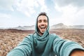 Handsome man taking selfie photo with smart mobile phone device outside - Cheerful climber hiking mountains Royalty Free Stock Photo