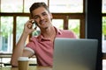 Handsome man talking on mobile phone in cafe Royalty Free Stock Photo