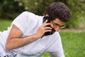 Handsome man talking on the phone in the park Royalty Free Stock Photo