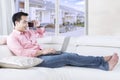 Handsome man talks on cellphone at couch Royalty Free Stock Photo