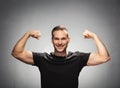 Handsome man tightening his muscles. Power gesture. Royalty Free Stock Photo