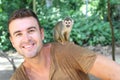 Handsome man with titi monkey on his shoulder Royalty Free Stock Photo