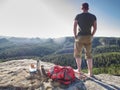 Handsome man took rest for snack. Tourist stay on summit rock Royalty Free Stock Photo