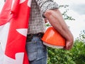 Handsome man with tools, holding a Canadian Flag Royalty Free Stock Photo