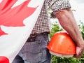 Handsome man with tools, holding a Canadian Flag Royalty Free Stock Photo