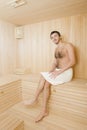Handsome man in a towel relaxing in sauna Royalty Free Stock Photo