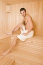 Handsome man in a towel relaxing in sauna Royalty Free Stock Photo