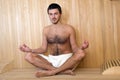 Handsome man in a towel relaxing in sauna Royalty Free Stock Photo