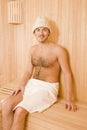 Handsome man in a towel relaxing in sauna Royalty Free Stock Photo