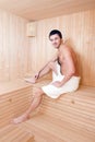 Handsome man in a towel relaxing in sauna Royalty Free Stock Photo