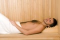 Handsome man in a towel relaxing in sauna Royalty Free Stock Photo