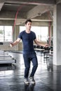 Handsome man training with his skipping rope best cardio workout at fitness gym