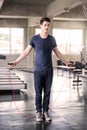 Handsome man training with his skipping rope best cardio workout at fitness gym