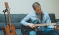 Handsome man tuning his semi-acoustic guitar Royalty Free Stock Photo