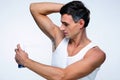 Handsome man using deodorant Royalty Free Stock Photo