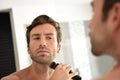 Handsome man using electrical razor Royalty Free Stock Photo